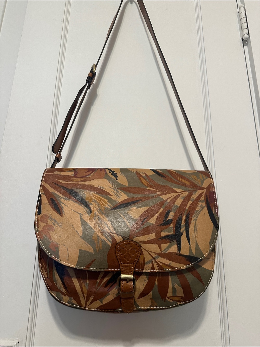 Patricia Nash Palm Leaf-Print Leather Crossbody 
Saddle Bag